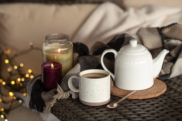 Cozy home composition with a cup of coffee and candles.