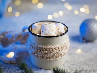 hot coffee, cocoa or chocolate with marshmallows. sweet dessert. Knitted scarf, bokeh garlands, winter time