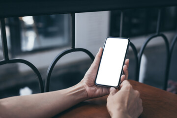 cell phone blank white screen mockup.woman hand holding texting using mobile on desk at office.background empty space for advertise.work people contact marketing business,technology