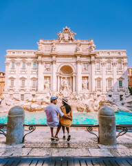 young couple mid age on a city trip in Rome Italy Europe, couple sightseeing visit Fontana di Trevi...