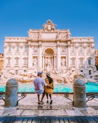 Poster de jardin Rome young couple mid age on a city trip in Rome Italy Europe, couple sightseeing visit Fontana di Trevi in Rome Italy