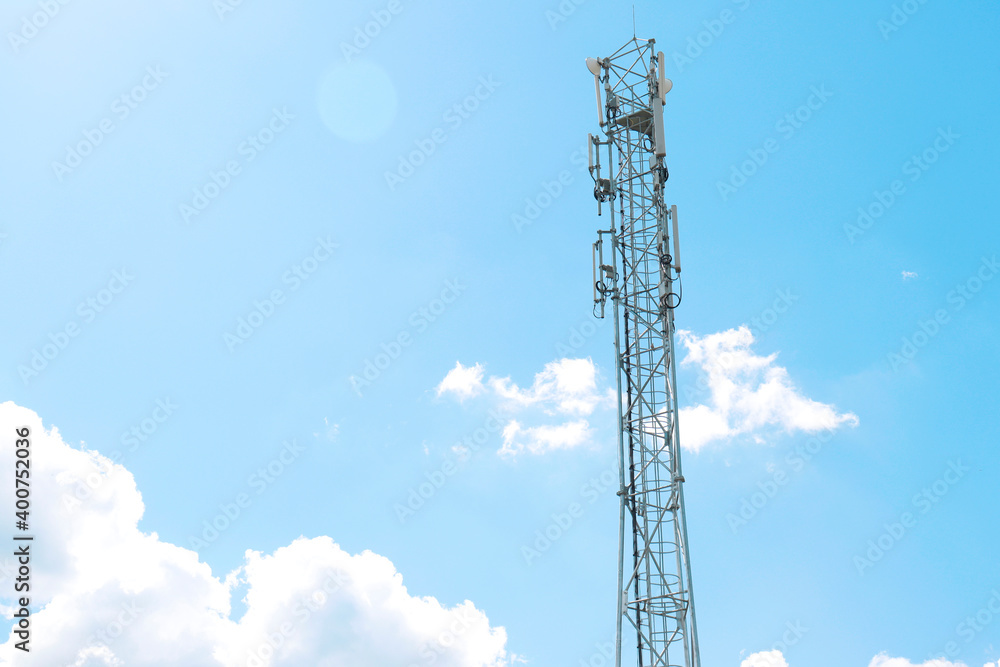 Poster communication tower against a blue sky