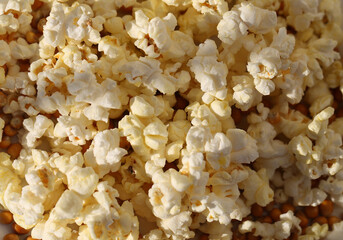 Photo background of salty popcorn illuminated by the sun