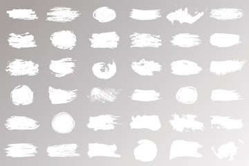 Collection of strokes, brushes, lines, roughness of white color isolated on beige background. Straight brush strokes. Modern textured shapes. Vector illustration.