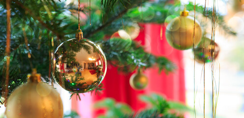 Christmas Ball hanging on a Fir Tree Branch. Christmas Background.