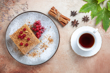 Obraz na płótnie Canvas top view cake slice with red berries and tea on light background pie sweet biscuit cake