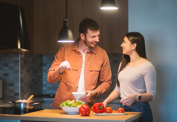 Sweet couple cooking together in their kitchen