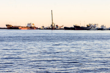 Obraz premium Big Lake Onega. In the background there is a harbor of cargo ships and barges after navigation.