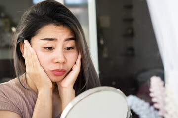 Asian woman having problem with eyes bags , dark circles, wrinkle and crow's feet on her face skin