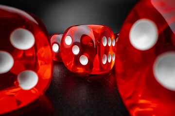 Group of playing dice cubes on black surface, macro