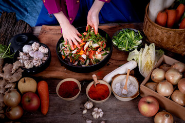 Close up images of Hand of Korean woman, she making Kimchi which is a fermented food preservation of Korean people consisting of many fresh vegetables and fruits