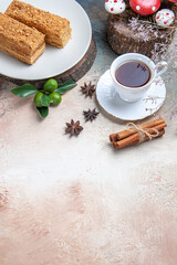 top view cake slices honey cake with cup of tea on light background sweet pie biscuit cake
