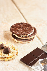 puffed corn cakes with chocolate and chocolated coated bananas. Healthy snack, healthy candy. Natural light.