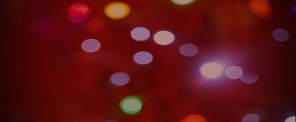 Festive bokeh on a red background. Merry christmas and Happy New Year. Background for the design.