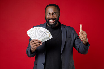 Cheerful young african american business man 20s wearing classic jacket suit standing hold fan of...