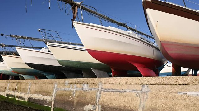 A row of yachts dry docked at the beautiful Dell Quay marina.