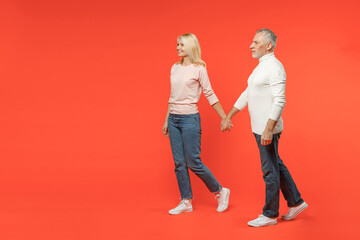 Full length of smiling couple two friends elderly gray-haired man blonde woman wearing white pink...