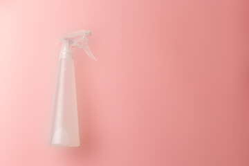White water sprayer on pastel pink background. Refresh concept. Flat lay. Copy space. Device for use to add water or liquid. Close-up
