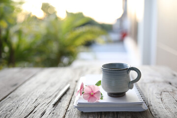 Asian clay ceramic cup and flower and notebook 
