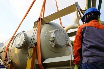 Large chemical tank are being lifted up for installation in the chemical plant construction project.