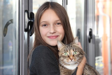 Smiling cute girl with domestic cat