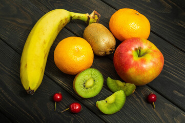 Set of fruits on a vintage black table for composing diet and supply of vitamins