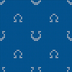 Seamless knitting pattern with horseshoes for sweater, mitten or other textile design is on blue background. Save with the Clipping Mask.