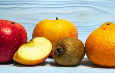 Set of fruits on a wooden blue background for composing diet and supply of vitamins