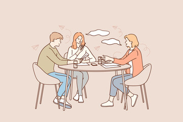 Brainstorming, teamwork, business group concept. Group of young positive business workers sitting at desk, working together reading documents and discussing ideas i office