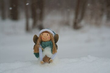 Figure of an angel in the winter snow. Christmas decorations.