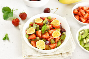 Healthy breakfast with fruit salad from strawberry, kiwi and banana
