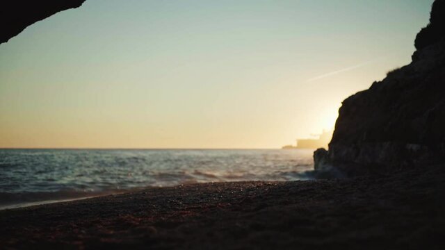sunset on a mediterranean beach with a woman doing exercise in it