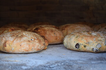 Traditional Cypriot bread with halloumi and black olive baked in a stone oven in the village garden.