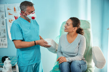 Kind medical worker talking to his patient