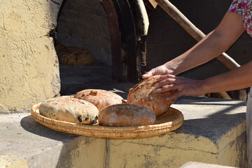 Traditional Cypriot bread with halloumi and black olive baked in a stone oven in the village garden.