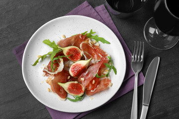 Delicious figs and proscuitto on plate, flat lay