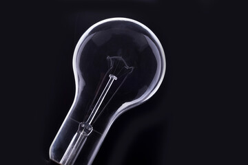Old electric bulb on a black background