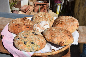 Traditional Cypriot bread with halloumi and black olive baked in a stone oven in the village garden.