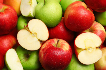 Naklejka na ściany i meble Many different whole and cut apples as background, closeup