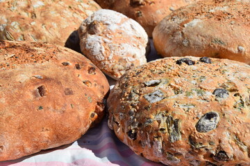 Traditional Cypriot bread with halloumi and black olive baked in a stone oven in the village garden.
