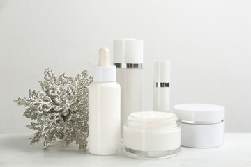 Fototapeta na wymiar Beautiful composition with different cosmetic products on white table. Winter care