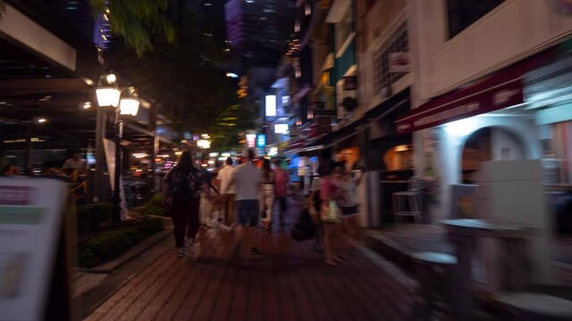 night time illuminated singapore city center crowded restaurant street walking timelapse panorama 4k 