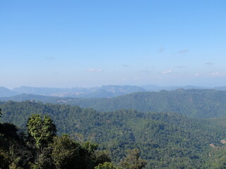 landscape in the morning with mountains and green forest. Sunlight over the green forest.