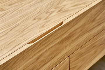 Stylish floating cabinet of light brown natural timber and finger pull design in contemporary...