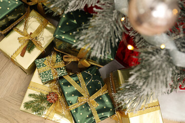 Fototapeta na wymiar Many different gifts under Christmas tree indoors, top view