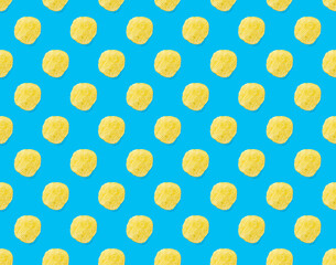 Seamless pattern made from Potato chips on light blue background flat lay. potato snack chips...