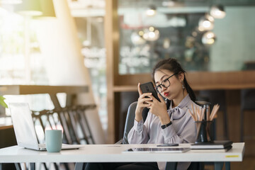 Portrait anxious young girl looking at phone seeing bad news or photos with disgusting emotion on her face.