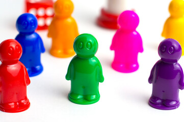 A group of multi-colored figures standing one after another. Team leadership concept.
