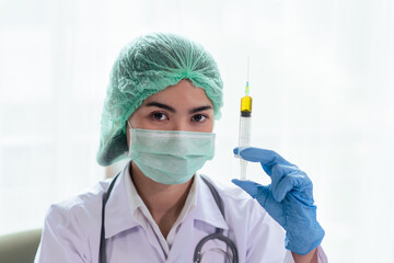 Female doctor or scientist with a stethoscope on shoulder holding syringe, Science and chemistry, Healthcare and Medical concept