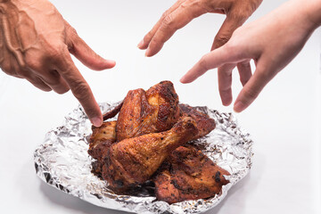 Hand hold grill chicken for meal.